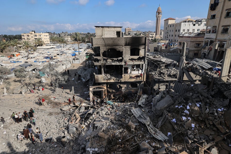 Palestinians inspect the rubble at the site of a residential building targeted overnight by an Israeli strike in Deir el-Balah in the central Gaza Strip on May 24, 2026.