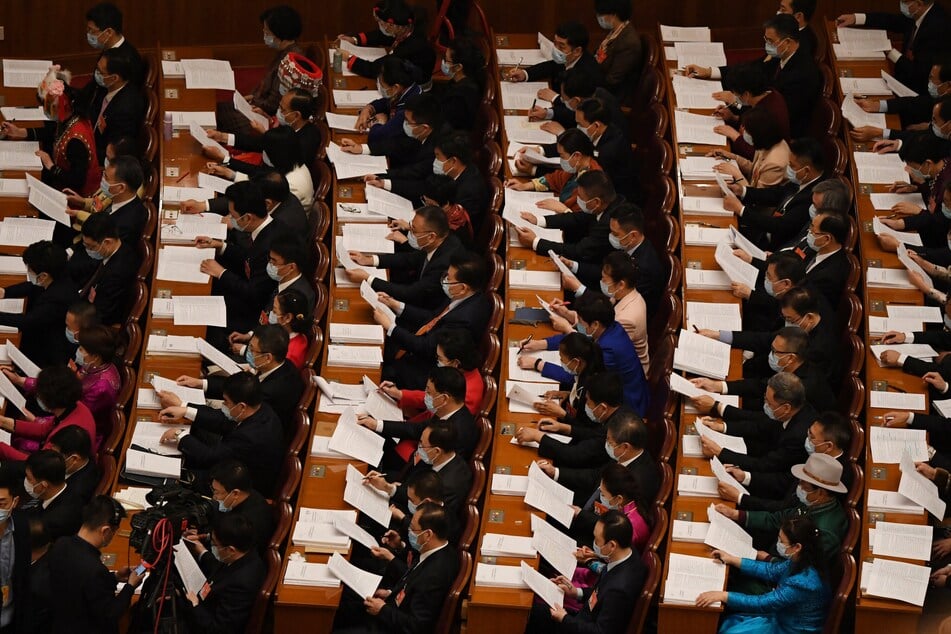 China's parliament has vowed to uphold its "red lines" but expressed a willingness to communicate with the US over Iran.